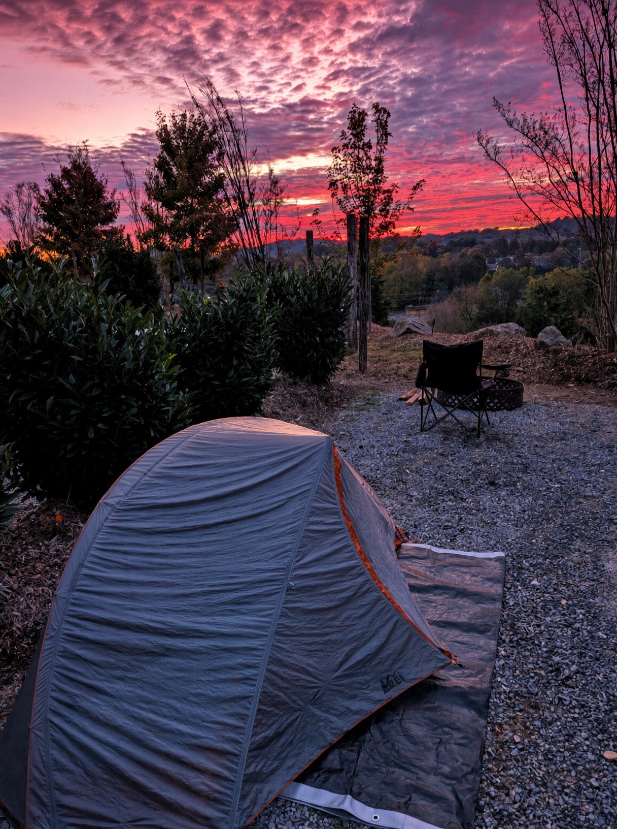 Tent at Camp Quarry Trails beneath a vivid evening sky
